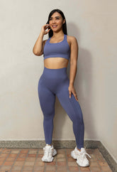 Mujer usando conjunto deportivo seamless azul con leggings y top push up de lycra texturizada, cómodo y moldeador.